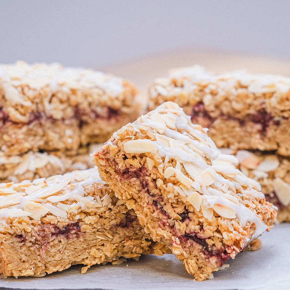 Close-up of granola bars with white drizzle on a light background
