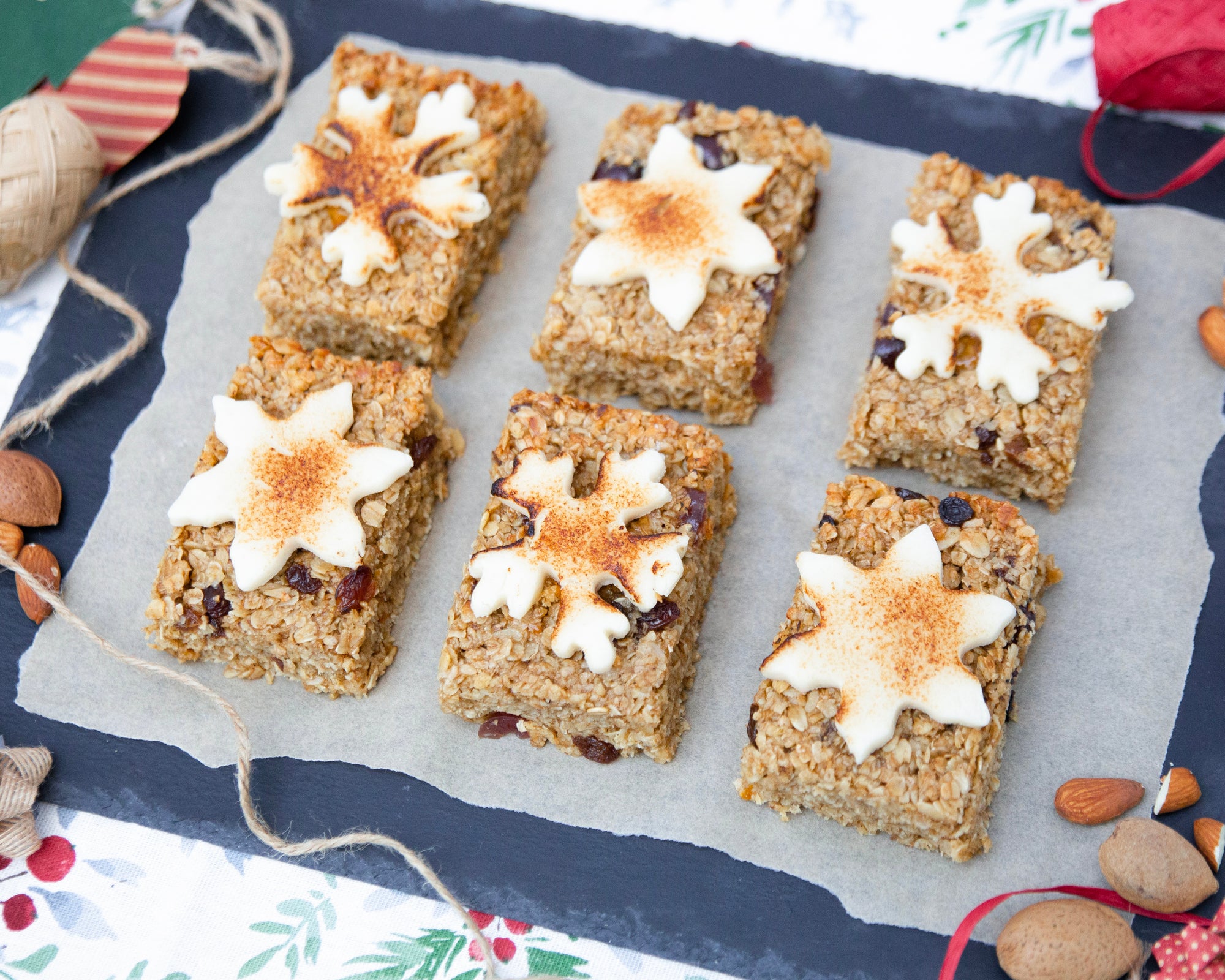 Square baked goods with white snowflake decorations on a festive background