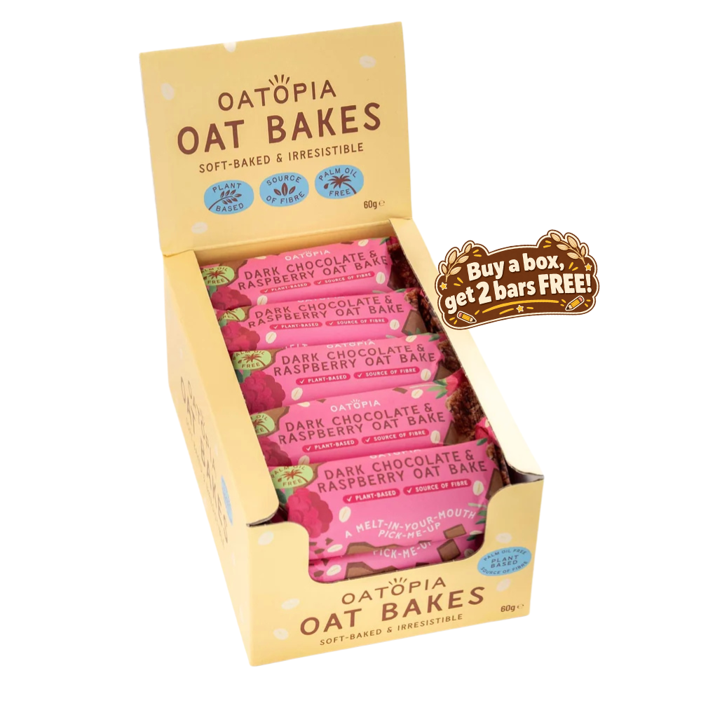 A box of Oatòpia Oat Bakes, Dark Chocolate & Raspberry Oat Bars, shown in its open display packaging. The packaging is a light beige cardboard tray containing multiple pink wrapped bars, with a promotional sticker on the right side offering a free bar.