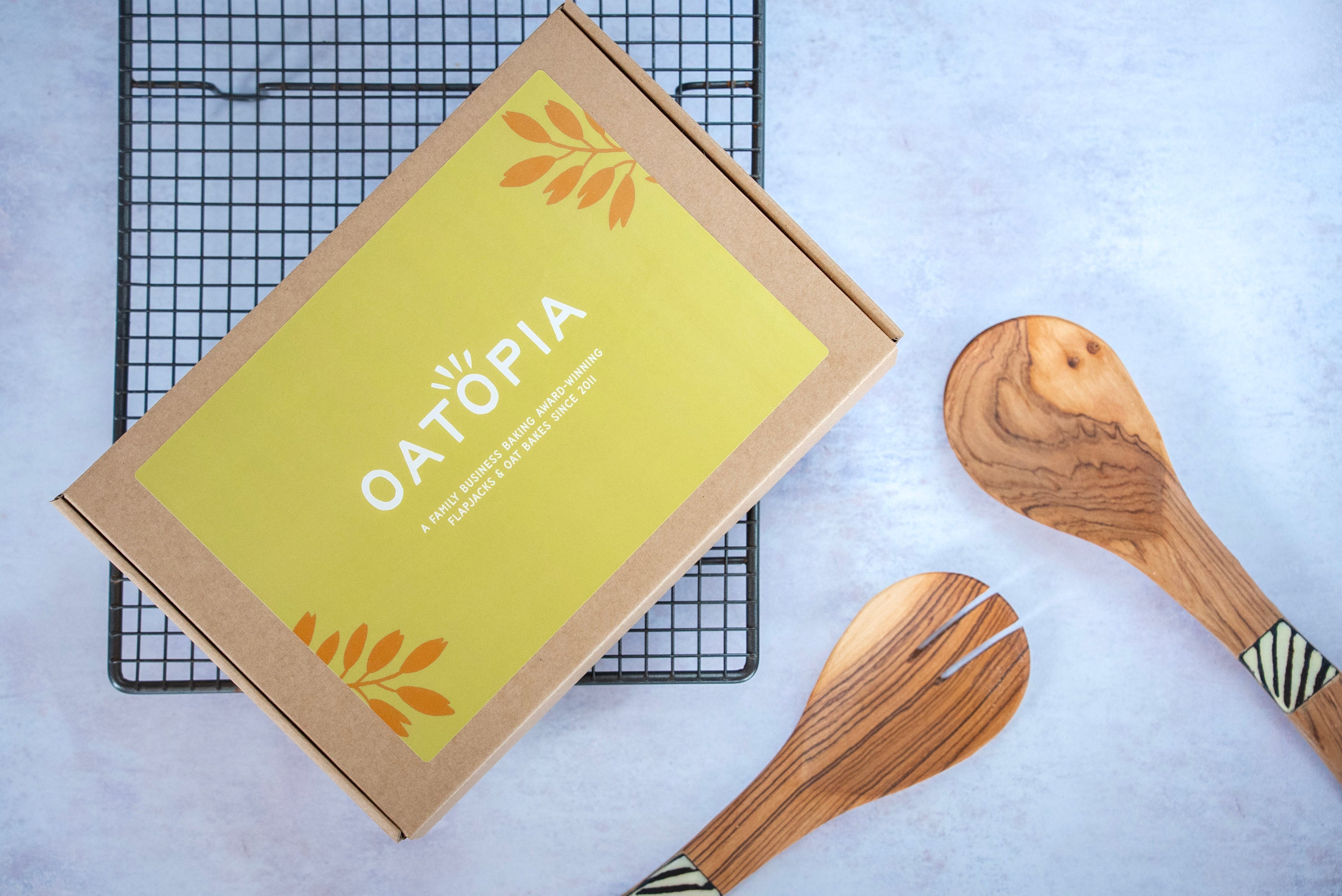 OATOPIA box with wooden utensils on a light background