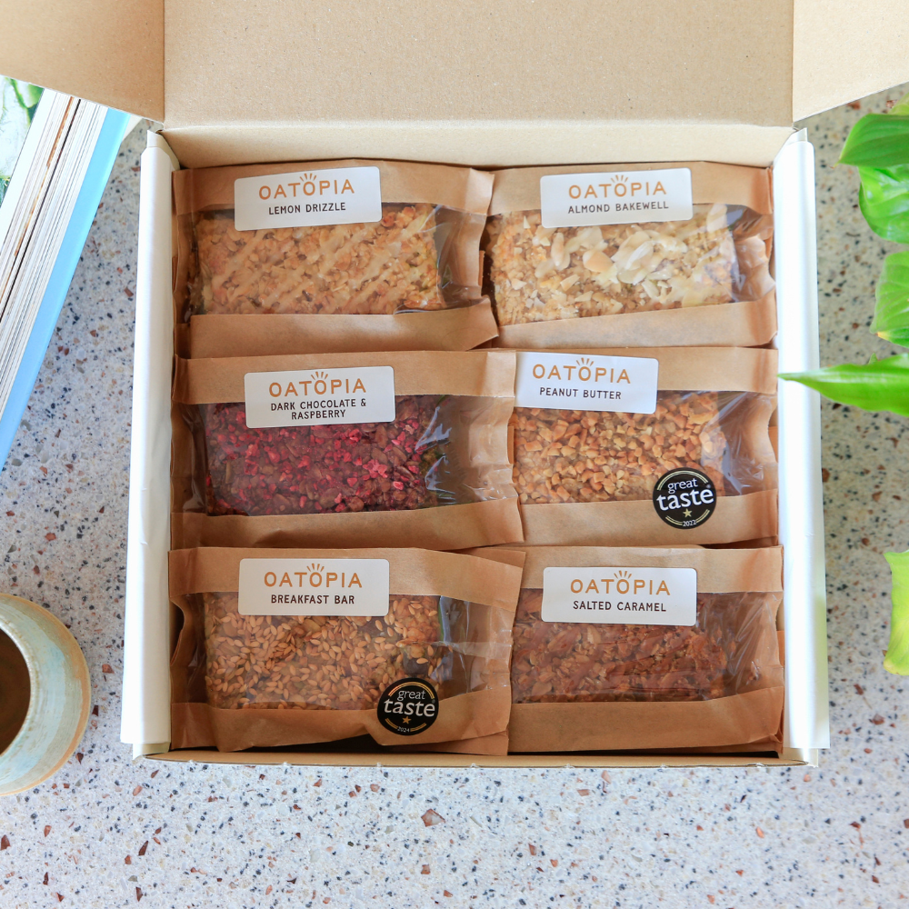 Overhead view of six individually wrapped Oatopia flapjacks arranged in an open Best Seller gift box.