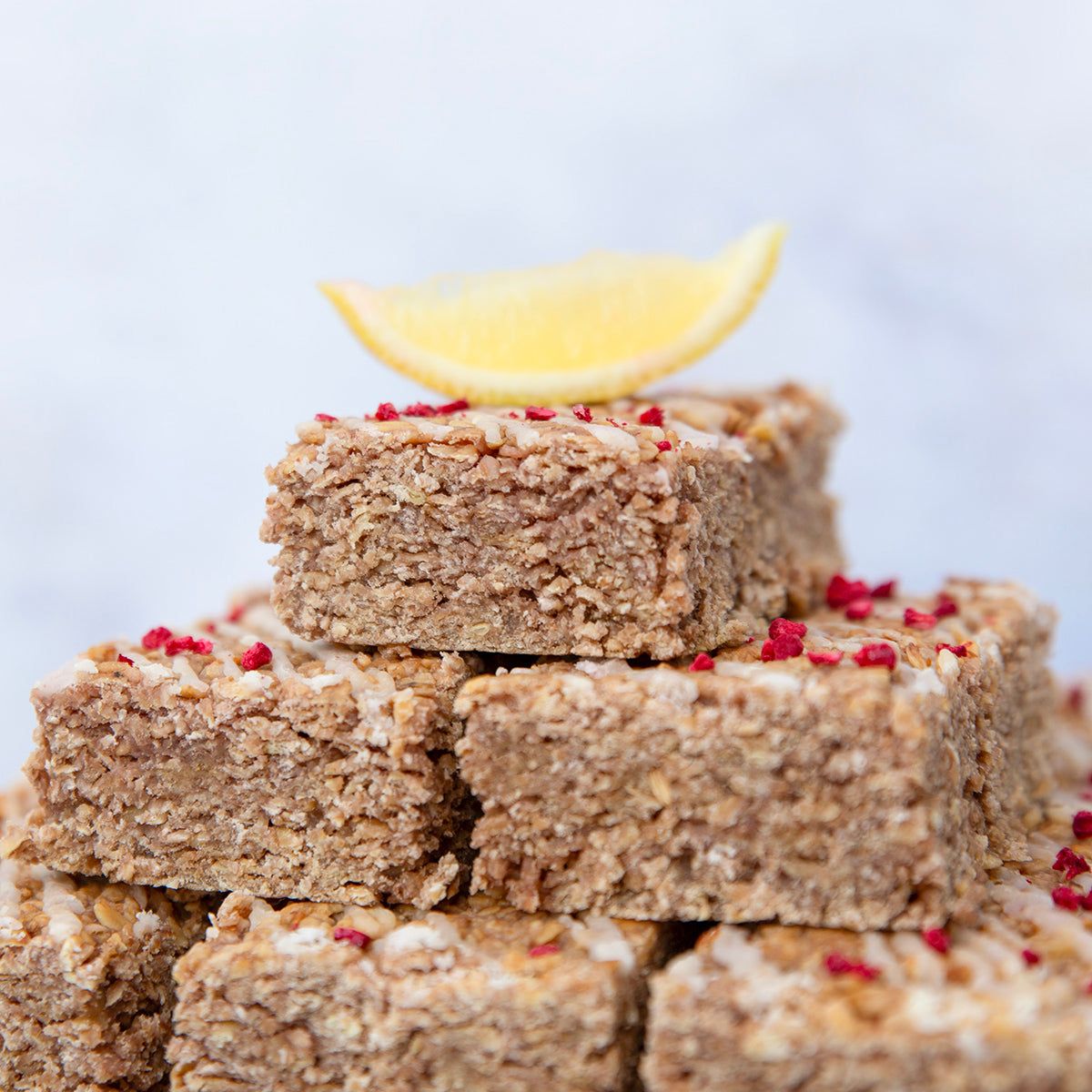 Handmade Lemon & Raspberry Flapjack with zesty lemon, sweet raspberry, and caramelised oat base, vegan and soft baked.