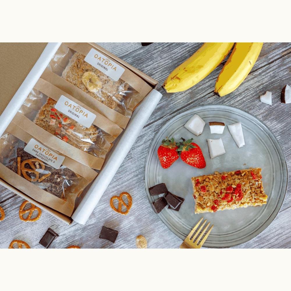 A plate featuring soft baked flapjacks with bananas, pretzels, strawberries, and chocolate, perfect for summer snacking.