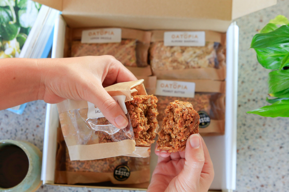 Individually wrapped Oatopia flapjack slices shown with an unwrapped piece