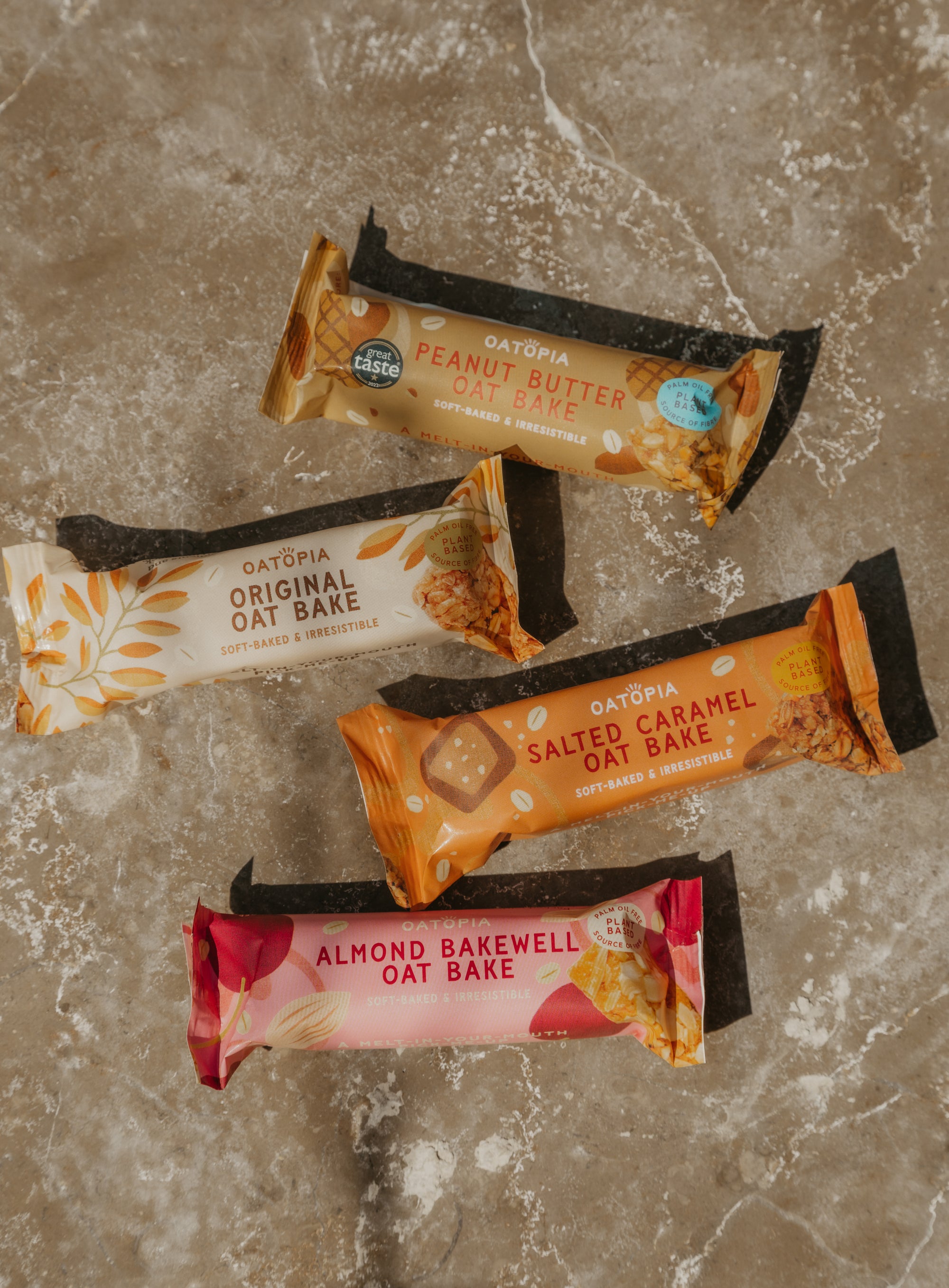 Five oatmeal bars from Oatopia on a textured surface