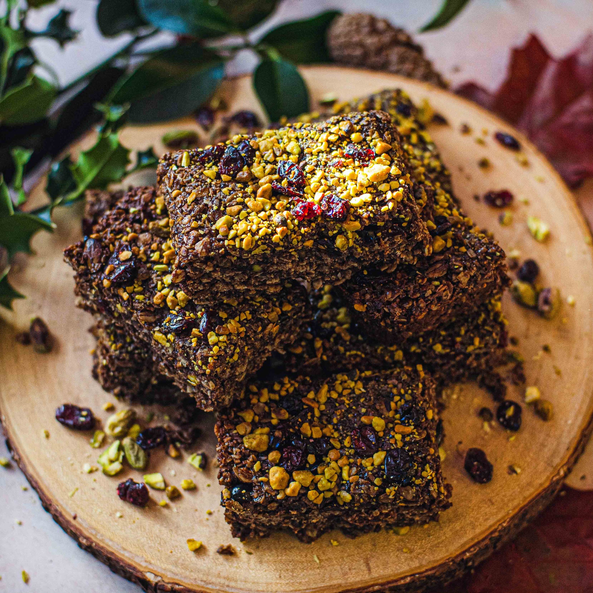 A tempting plate of brownies topped with nuts and dried fruit cranberry, inviting you to indulge in a delicious treat.