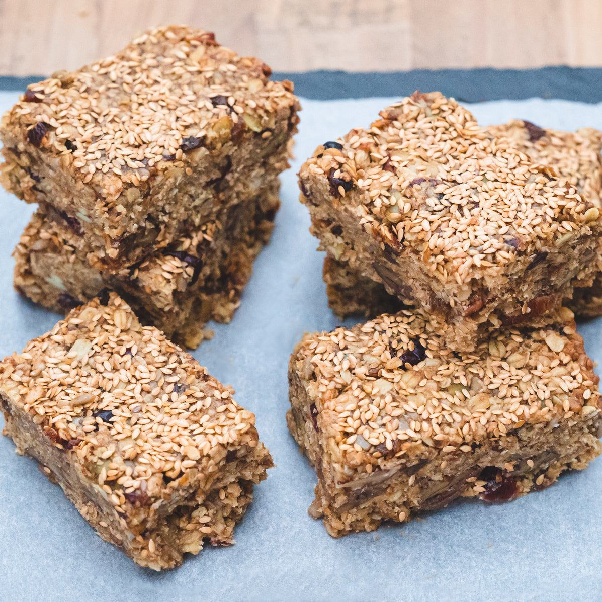 Fruit and nut flapjack bars with oats, dried fruit, and nuts, handmade and coated with sesame seeds in a gift box set