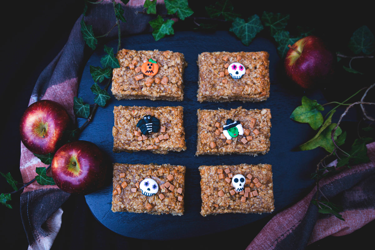 Festively decorated Halloween flapjack apple bars, showcasing vibrant colors and fun spooky designs for a seasonal delight.